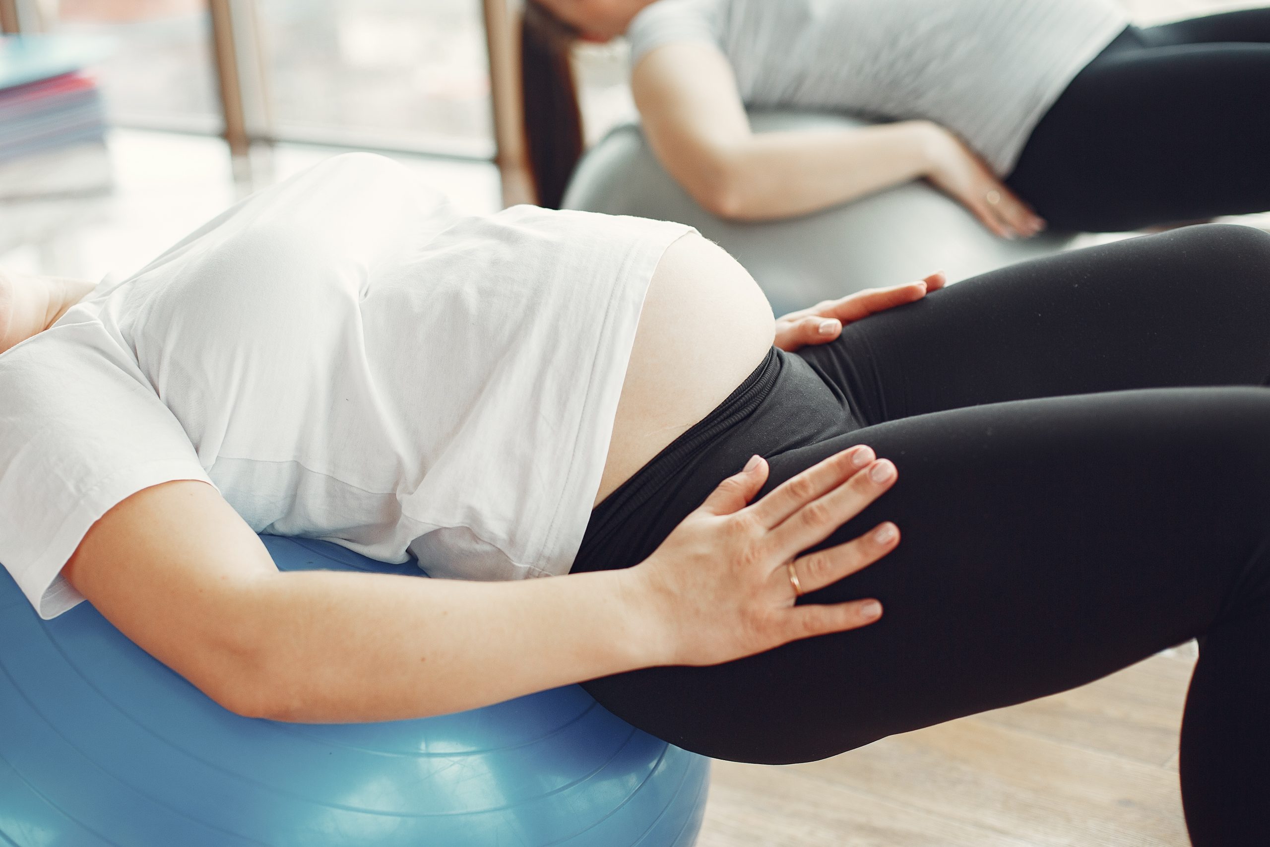 Pregnant women doing yoga in a gym